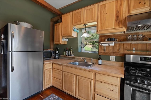 kitchen featuring a sink, light brown cabinetry, stainless steel appliances, beam ceiling, and dark wood-style floors