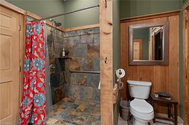 full bath featuring toilet and tiled shower