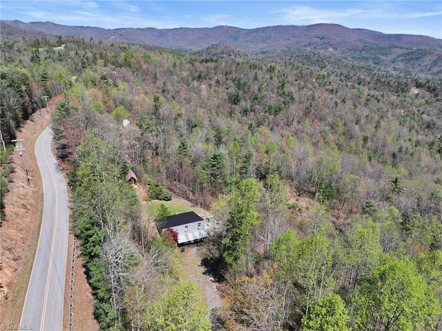 aerial view featuring a forest view and a mountain view
