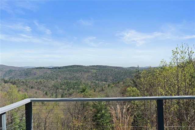 property view of mountains featuring a forest view
