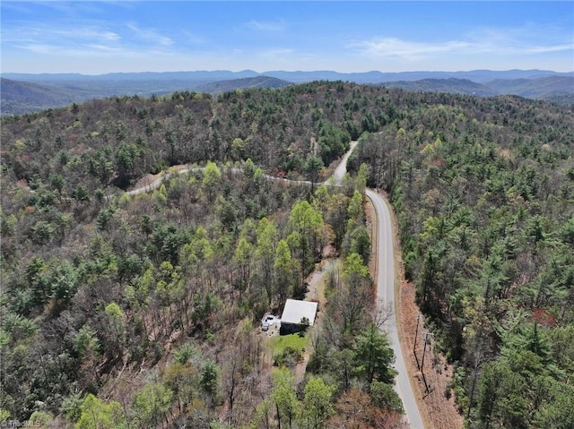 bird's eye view featuring a wooded view and a mountain view