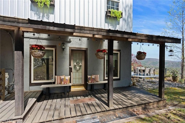 property entrance with a deck with mountain view