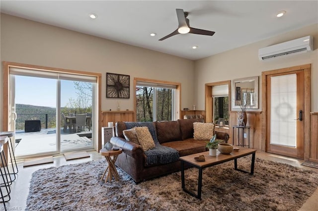 living room featuring recessed lighting, a wall mounted AC, and a ceiling fan