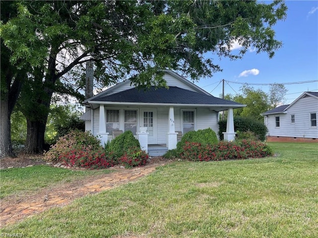 view of front of house with a front lawn and covered porch