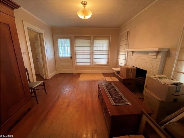 unfurnished living room featuring crown molding, hardwood / wood-style flooring, and a fireplace