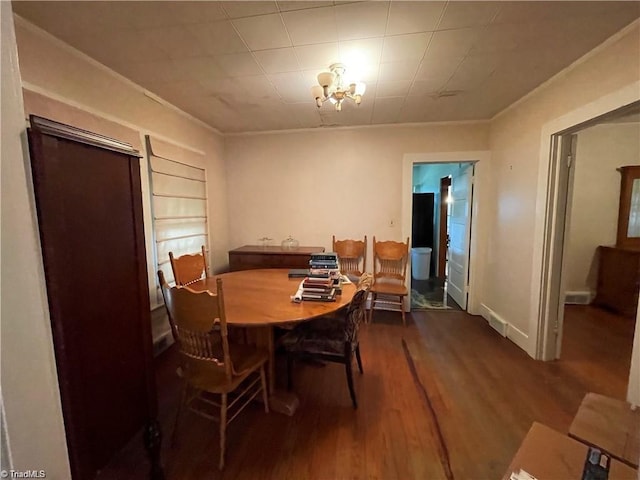 dining space with a notable chandelier and hardwood / wood-style floors