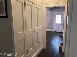 hallway featuring dark hardwood / wood-style flooring