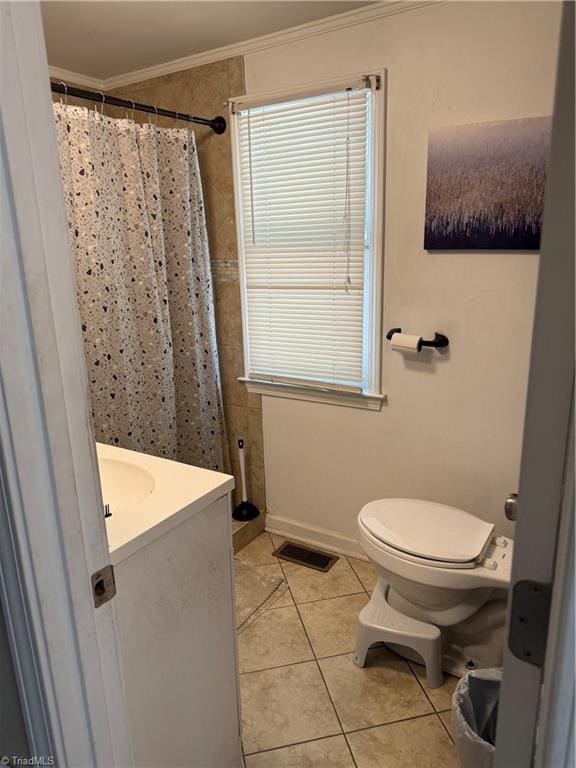 bathroom with toilet, visible vents, tile patterned flooring, crown molding, and vanity