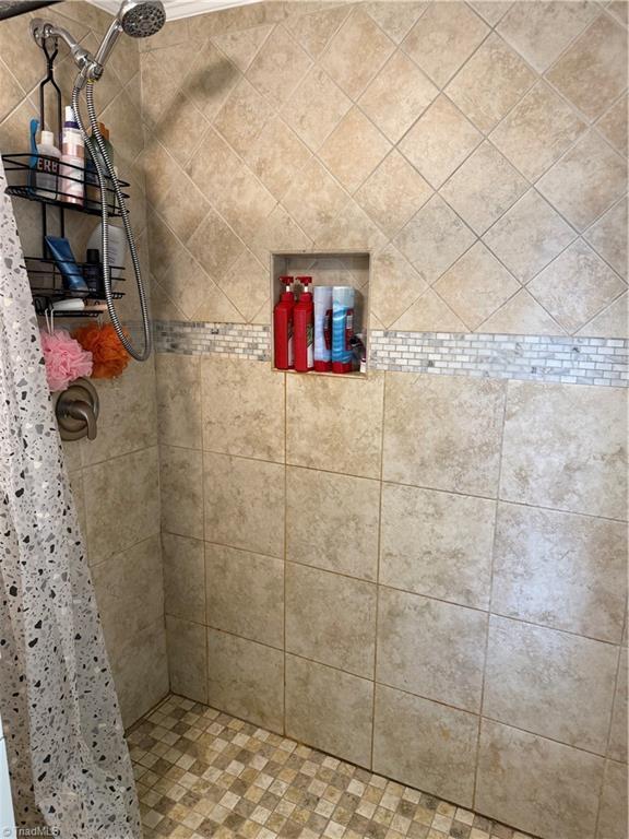 full bathroom with tiled shower
