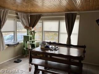 dining area with light tile patterned flooring and wooden ceiling