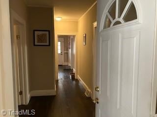 corridor with dark wood-type flooring