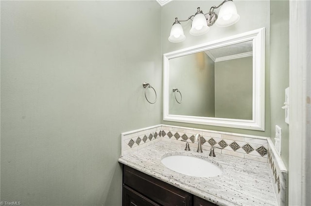 bathroom featuring ornamental molding and vanity