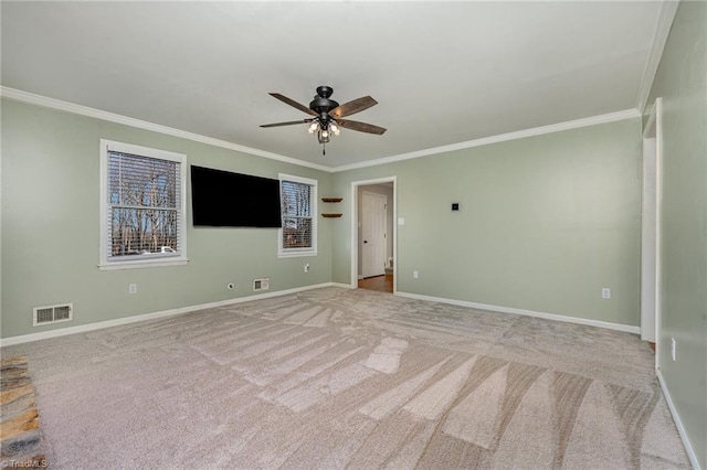 empty room with a ceiling fan, visible vents, crown molding, and baseboards