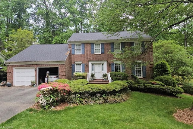 1808 Dunleith Way, Greensboro, NC 27455 - colonial house featuring asphalt driveway, an attached garage, brick siding, and a front lawn