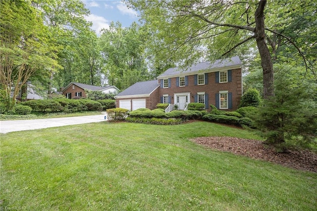 1808 Dunleith Way, Greensboro, NC 27455 - colonial home featuring driveway, brick siding, a garage, and a front yard