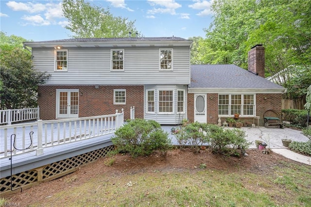 1808 Dunleith Way, Greensboro, NC 27455 - rear view of property with french doors, brick siding, a deck, a patio area, and a chimney
