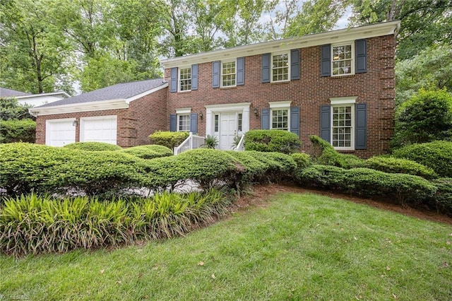 1808 Dunleith Way, Greensboro, NC 27455 - colonial inspired home featuring brick siding, a front lawn, and a garage