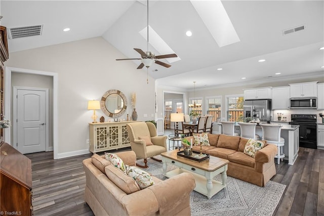 living room featuring visible vents, dark wood-style flooring, and a ceiling fan