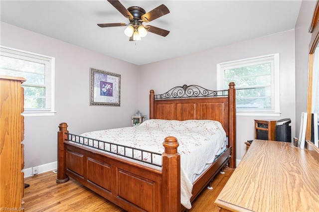 422 Hyde St, Burlington, NC 27217 - bedroom with light wood finished floors, baseboards, and ceiling fan