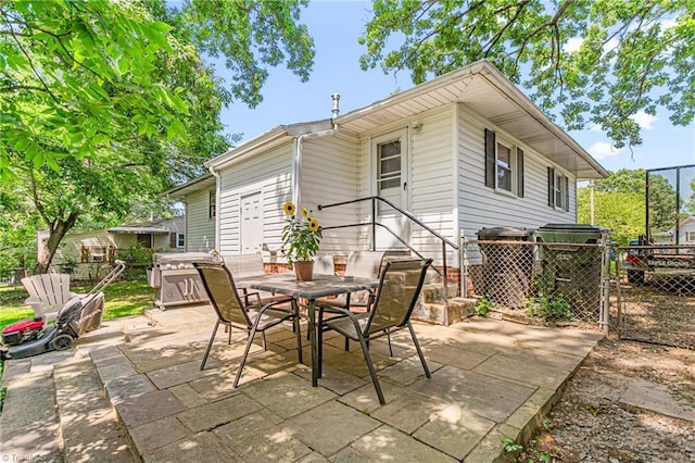 422 Hyde St, Burlington, NC 27217 - view of patio with outdoor dining area, a covered hot tub, and a gate