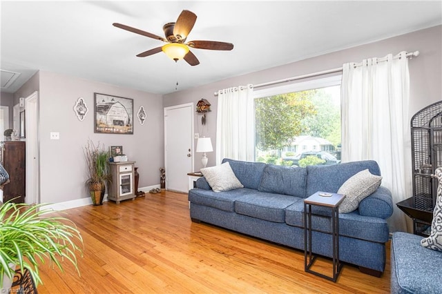 422 Hyde St, Burlington, NC 27217 - living room with light wood finished floors, a ceiling fan, baseboards, and attic access