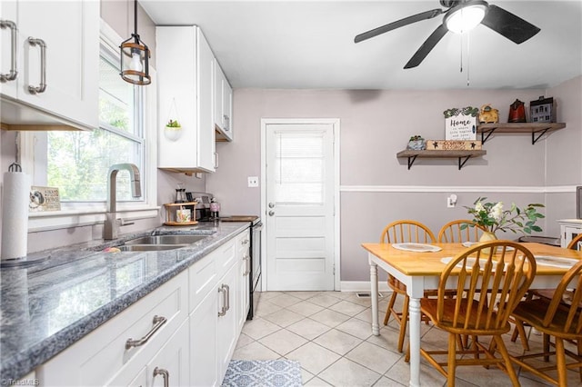 422 Hyde St, Burlington, NC 27217 - kitchen featuring a sink, light tile patterned floors, white cabinets, stainless steel electric range oven, and a ceiling fan