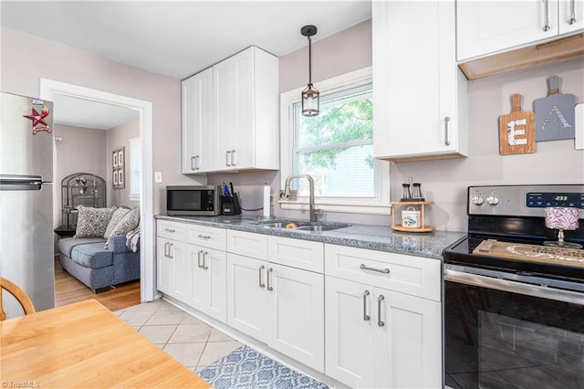 422 Hyde St, Burlington, NC 27217 - kitchen with appliances with stainless steel finishes, a sink, white cabinets, and light stone counters