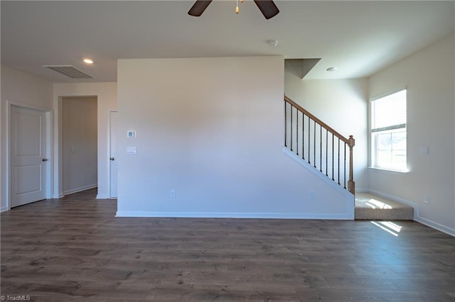 unfurnished living room with a ceiling fan, stairs, baseboards, dark wood-style flooring, and recessed lighting