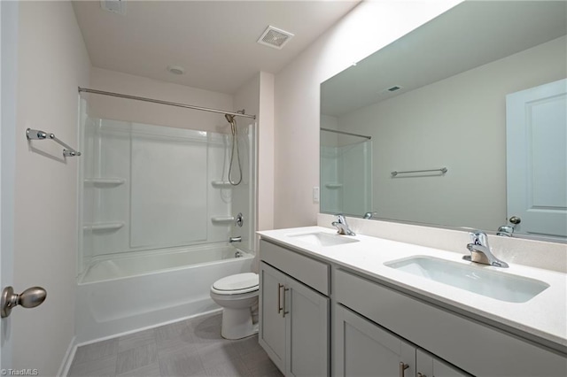 bathroom featuring toilet, double vanity, tub / shower combination, baseboards, and tile patterned floors