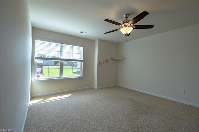 unfurnished room with light colored carpet, ceiling fan, and baseboards