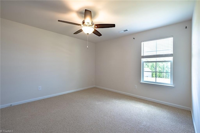empty room with ceiling fan, carpet flooring, and baseboards