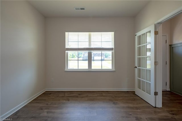 unfurnished room with wood finished floors and baseboards