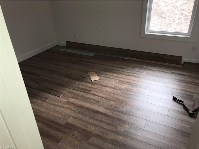 spare room with dark hardwood / wood-style flooring