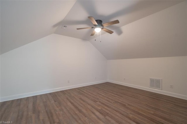 additional living space with ceiling fan, dark hardwood / wood-style floors, and vaulted ceiling