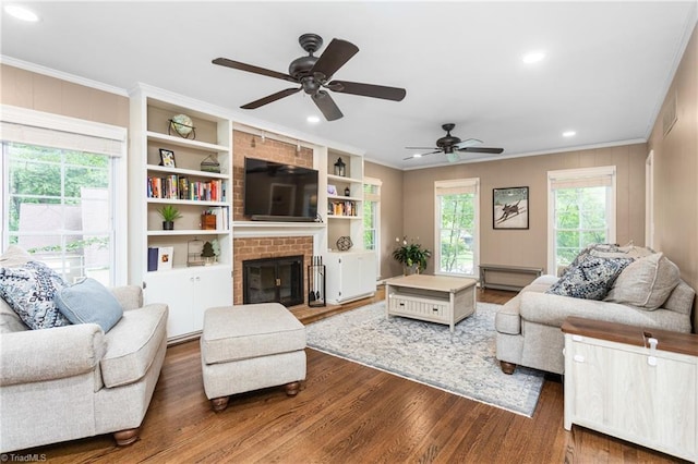 3717 Rock Haven Dr, Greensboro, NC 27410 - living area featuring ornamental molding, wood finished floors, a ceiling fan, a brick fireplace, and recessed lighting
