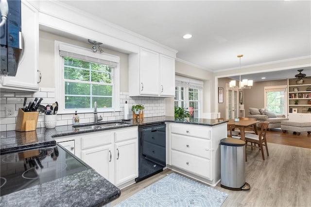 3717 Rock Haven Dr, Greensboro, NC 27410 - kitchen with black appliances, crown molding, open floor plan, a peninsula, and white cabinetry