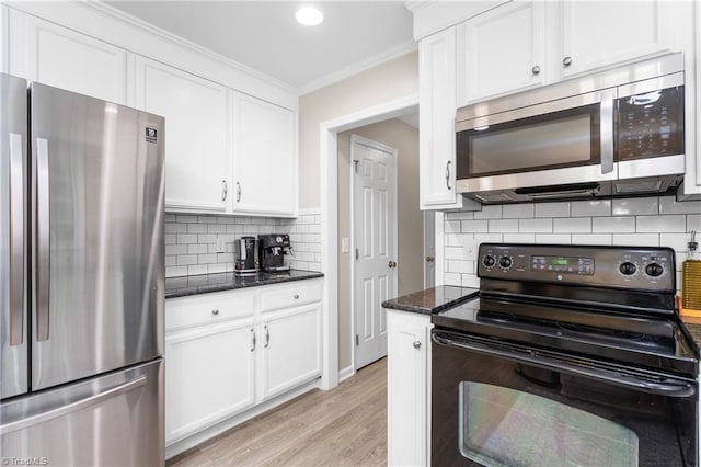 3717 Rock Haven Dr, Greensboro, NC 27410 - kitchen featuring appliances with stainless steel finishes, crown molding, light wood-type flooring, decorative backsplash, and white cabinetry