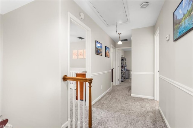 3717 Rock Haven Dr, Greensboro, NC 27410 - hallway with attic access, carpet floors, and an upstairs landing