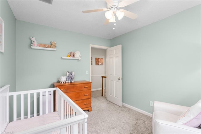 3717 Rock Haven Dr, Greensboro, NC 27410 - carpeted bedroom featuring a crib and ceiling fan