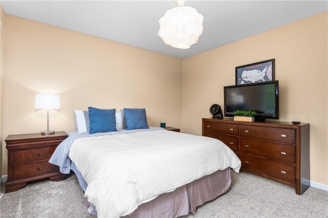 3717 Rock Haven Dr, Greensboro, NC 27410 - bedroom featuring light colored carpet and baseboards