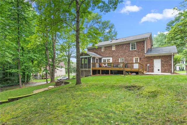 3717 Rock Haven Dr, Greensboro, NC 27410 - back of house featuring a sunroom, a deck, brick siding, and a lawn