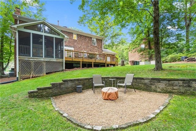 3717 Rock Haven Dr, Greensboro, NC 27410 - rear view of house featuring a sunroom, a lawn, a deck, and a chimney