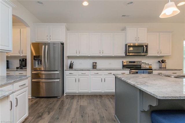 5968 Crescentbrook Ln, Clemmons, NC 27012 - kitchen with stainless steel appliances, white cabinets, dark wood-style flooring, arched walkways, and recessed lighting