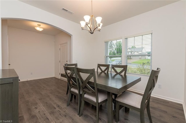 5968 Crescentbrook Ln, Clemmons, NC 27012 - dining area with arched walkways, dark wood-style flooring, a chandelier, and baseboards