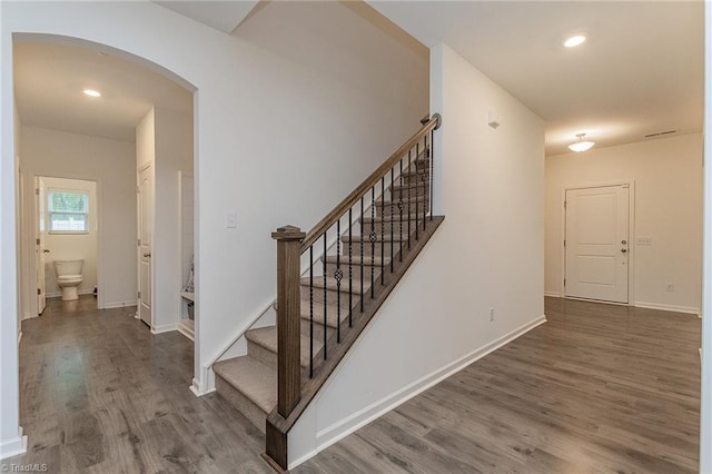 5968 Crescentbrook Ln, Clemmons, NC 27012 - stairway with arched walkways, wood finished floors, baseboards, and recessed lighting