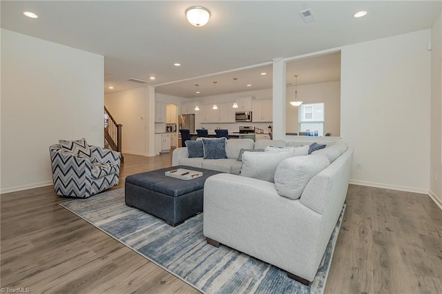 5968 Crescentbrook Ln, Clemmons, NC 27012 - living room with wood finished floors, stairway, recessed lighting, and baseboards