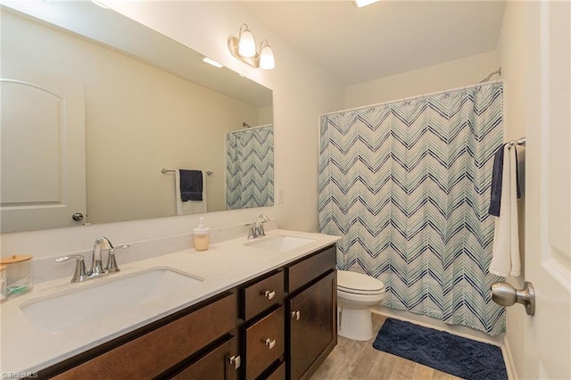 5968 Crescentbrook Ln, Clemmons, NC 27012 - full bathroom with wood finished floors, toilet, double vanity, and a shower with shower curtain