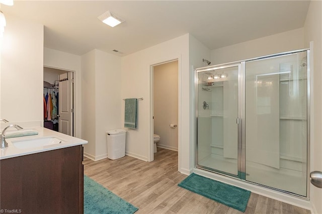5968 Crescentbrook Ln, Clemmons, NC 27012 - bathroom featuring a stall shower, wood finished floors, toilet, and baseboards