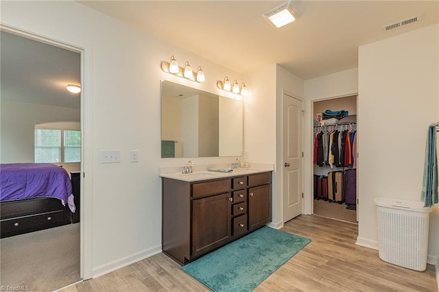 5968 Crescentbrook Ln, Clemmons, NC 27012 - full bath featuring wood finished floors, ensuite bathroom, double vanity, baseboards, and a spacious closet
