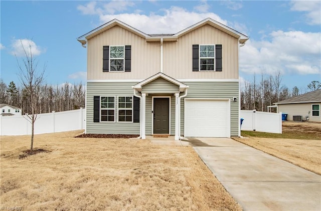 traditional-style house featuring an attached garage, central AC, fence, concrete driveway, and a front lawn